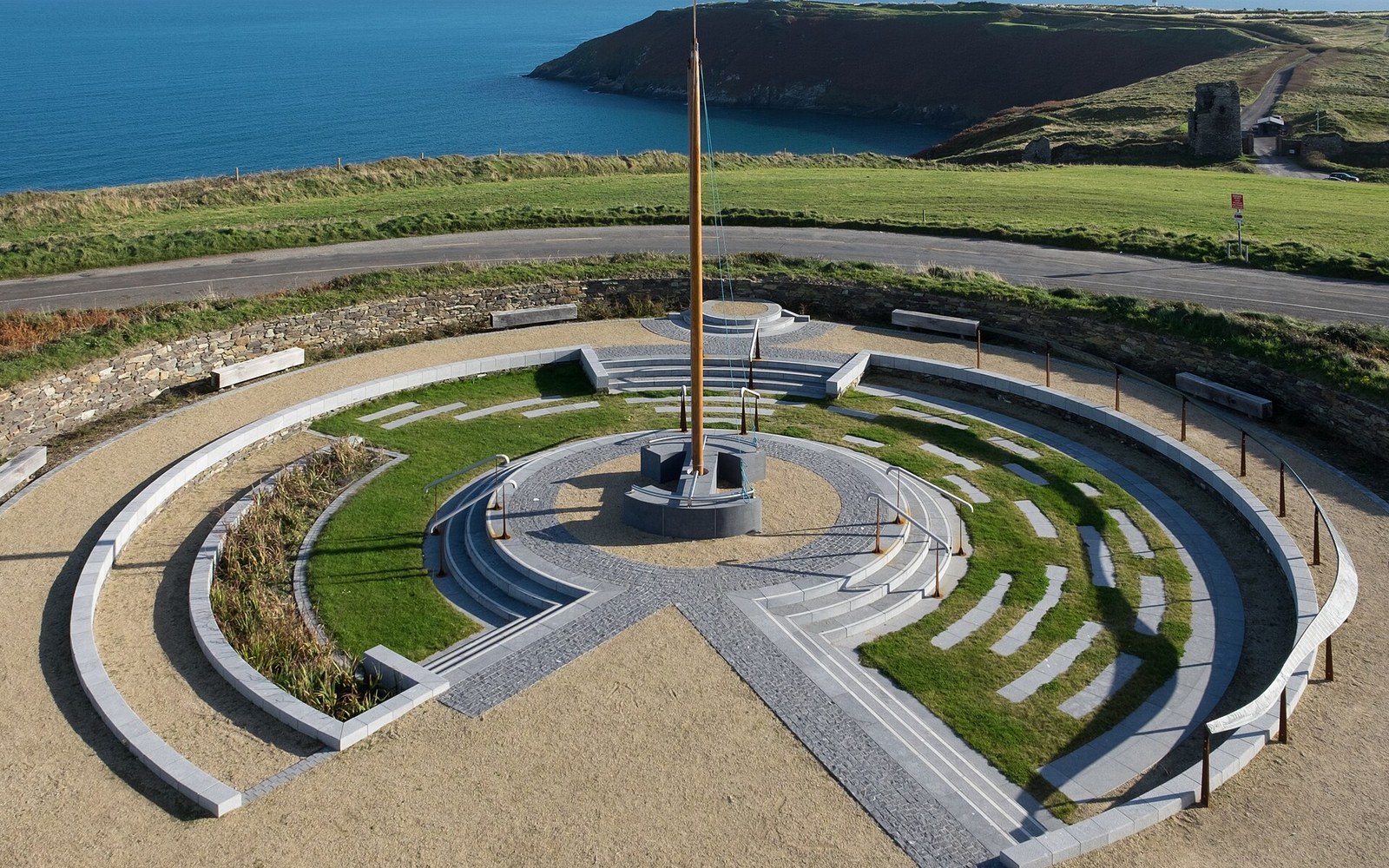 Old Head of Kinsale from the air, the full promontory visible with the Atlantic on three sides, course routing legible from altitude